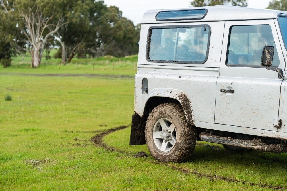Image of four wheel drive car in a field with mud Austockphoto