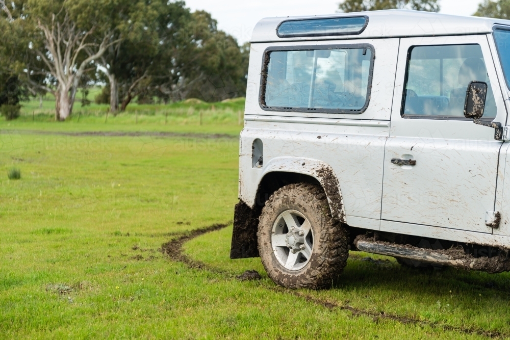 four wheel drive car in a field with mud - Australian Stock Image