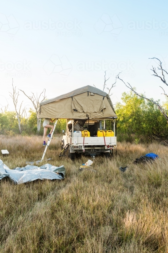 Four wheel drive with roof top tent set up for camping in the Outback - Australian Stock Image