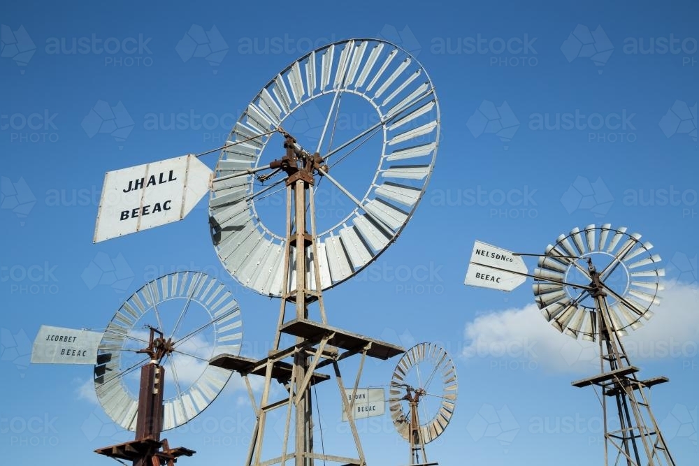 Four windmills against a blue sky - Australian Stock Image