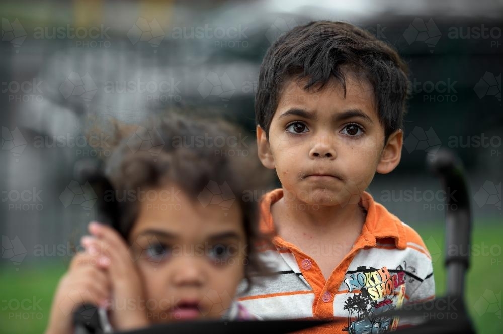 Four year Old Aboriginal Boy With Girl in Foreground - Australian Stock Image