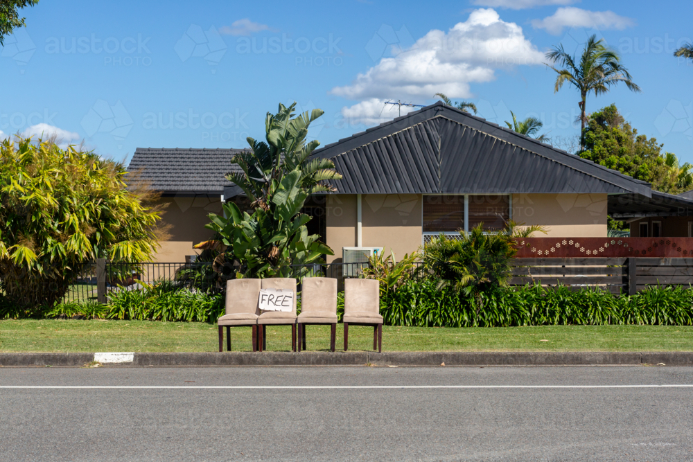 Free sign on chairs waiting for council clean up outside a suburban house - Australian Stock Image