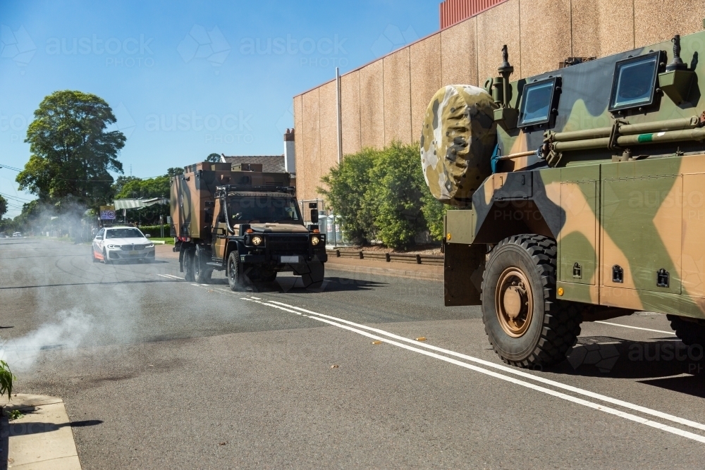Freedom of entry march with army vehicles driving through smoke at aboriginal smoking ceremony - Australian Stock Image