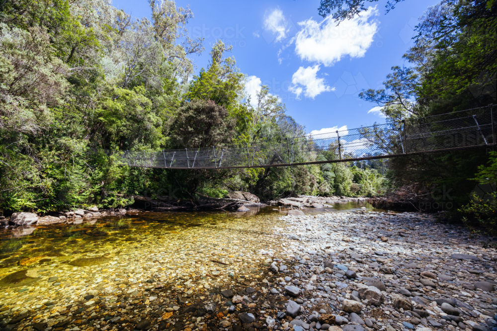 Frenchmans Cap Suspended Bridge in Franklin-Gordon Wild Rivers National Park on a hot summer's day - Australian Stock Image