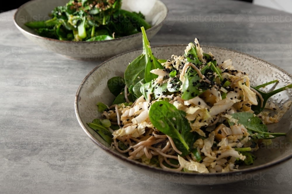 Fresh bowls of pasta on table - Australian Stock Image