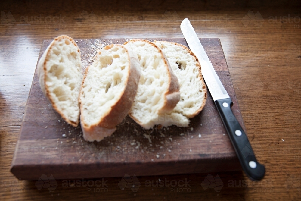 Fresh bread on wooden block - Australian Stock Image