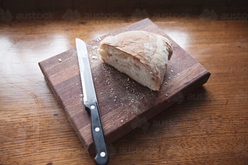 Fresh bread on wooden block - Australian Stock Image