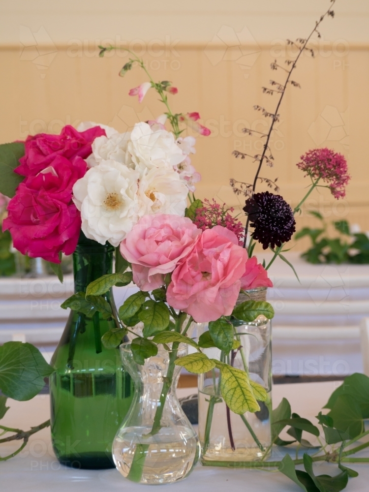 Fresh flowers on a table in vases - Australian Stock Image