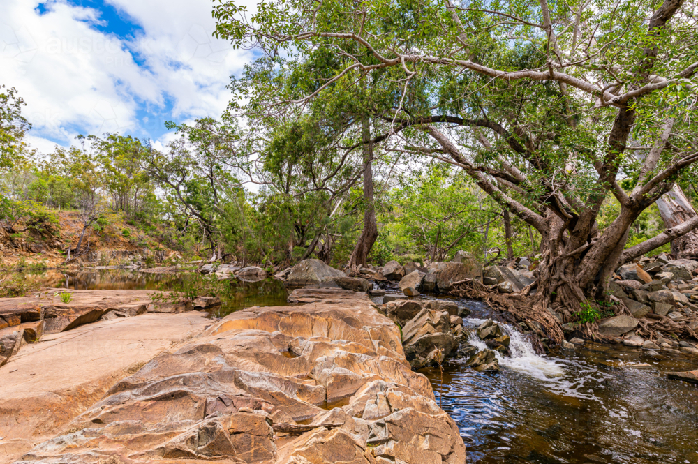 Fresh water creek and amongst boulders in the summer - Australian Stock Image