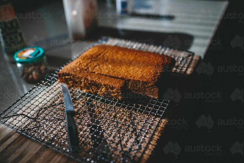 Freshly baked cake being cut - Australian Stock Image
