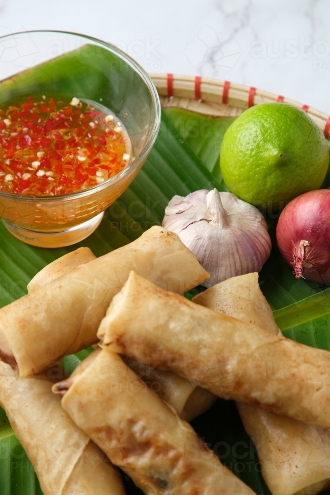 Freshly cooked Filipino food called Lumpiang Shanghai or fried pork spring rolls. - Australian Stock Image