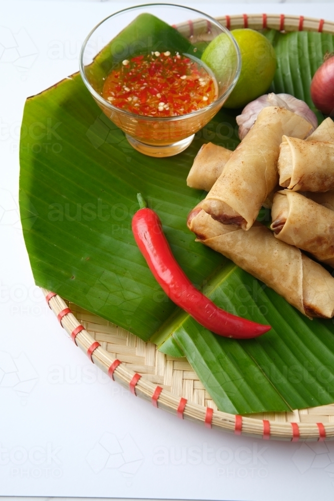 Freshly cooked Filipino food called Lumpiang Shanghai or fried pork spring rolls. - Australian Stock Image