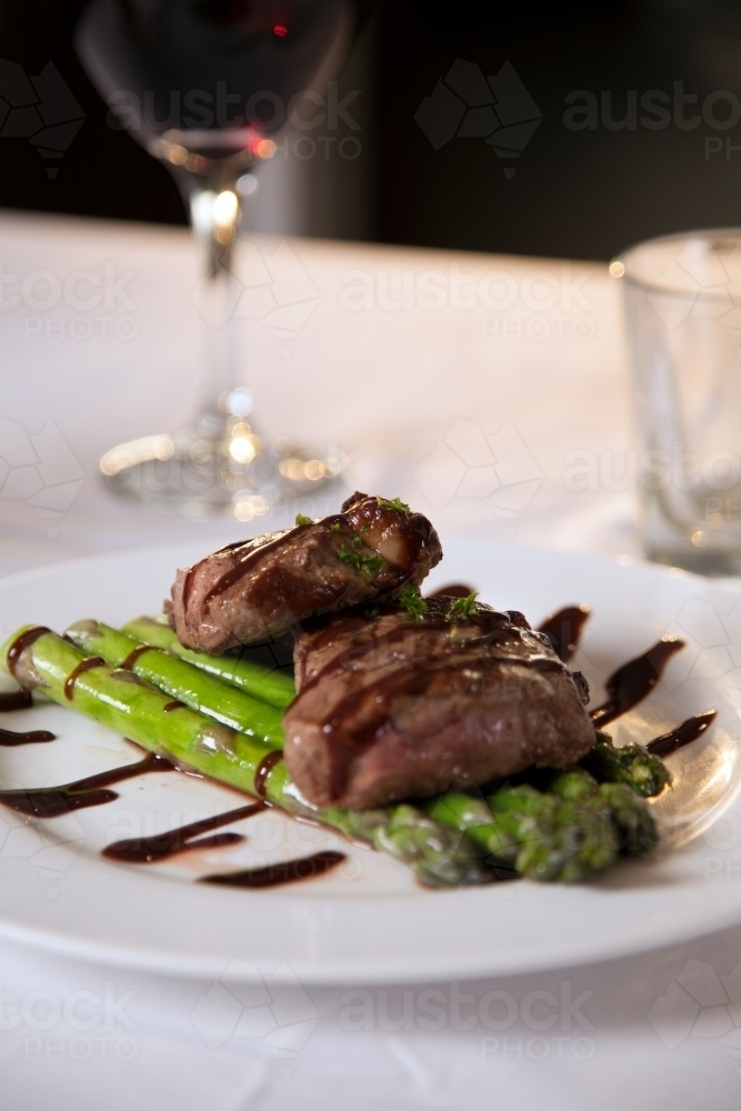 Freshly cooked steak on a plate with asparagus - Australian Stock Image