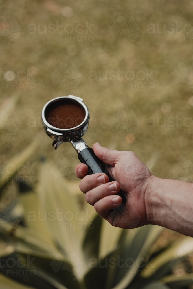 Freshly ground and tamped coffee ready to pull an espresso shot - Australian Stock Image