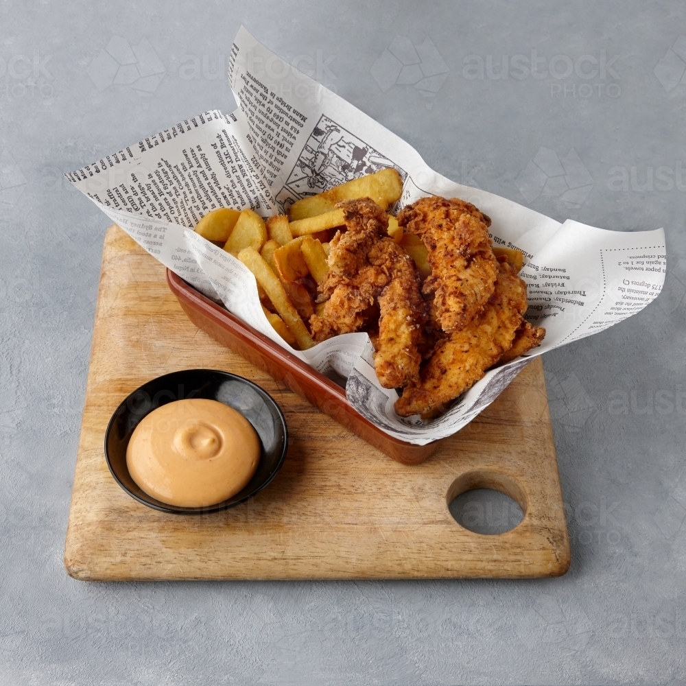 Fried chicken and chips on table - Australian Stock Image