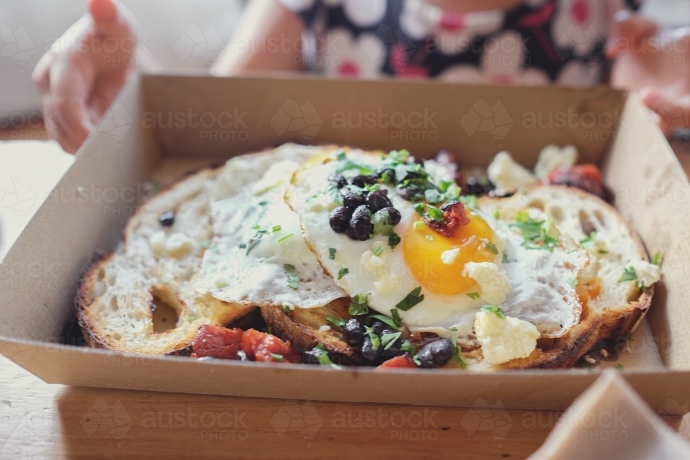 Fried eggs on wood fired sourdough toast - Australian Stock Image