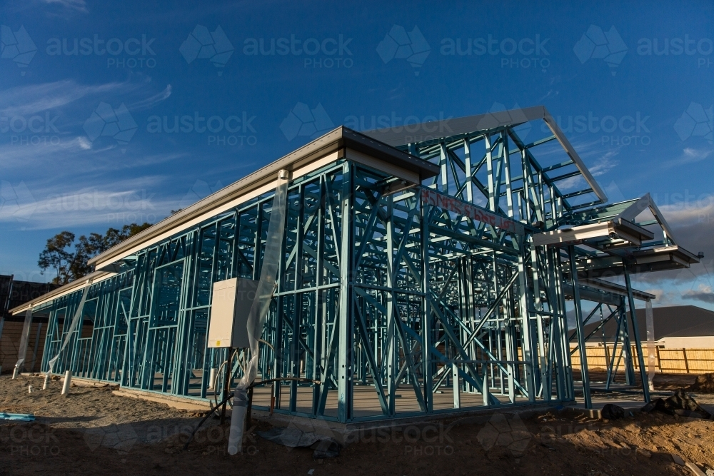 Image of front and side view of a steel house frame on a new estate ...