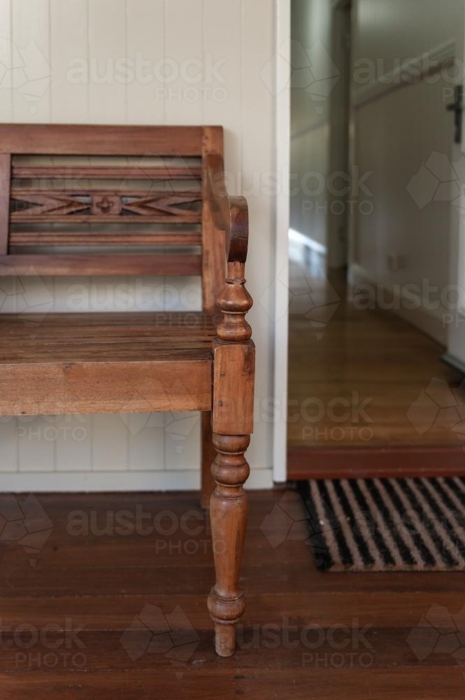 front door of a Queenslander home with a wooden bench on the verandah - Australian Stock Image