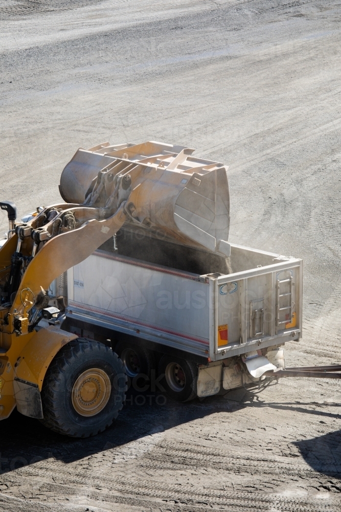 Front end loader loading a truck in mine - Australian Stock Image