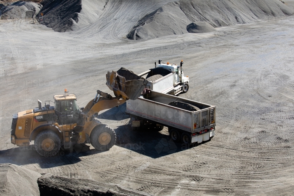 Front end loader loading a truck in mine - Australian Stock Image
