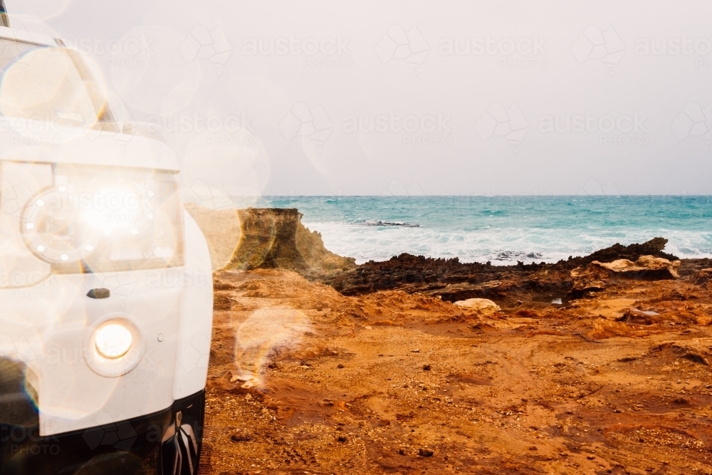 Front light of a four wheel drive car and the rocks near the sea - Australian Stock Image