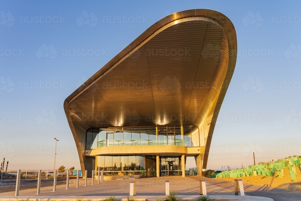 Front on elevation of a modern steel transit terminal with wide slow curved design - Australian Stock Image