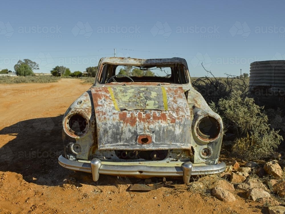 Front on shot of a rusty car in outback - Australian Stock Image