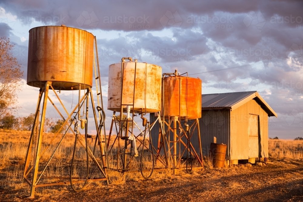 Fuel Bowsers on a farm with shed - Australian Stock Image