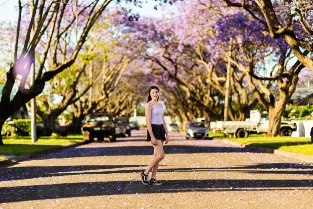 Full length portrait of a young teen girl standing in street of country town - Australian Stock Image