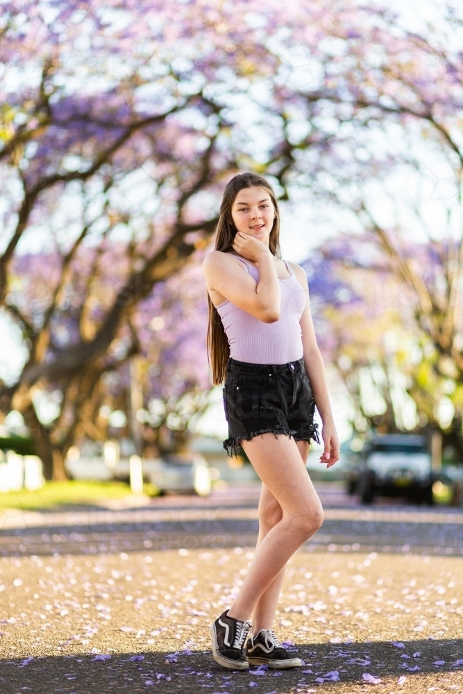 Full length portrait of teenager standing on the road - Australian Stock Image