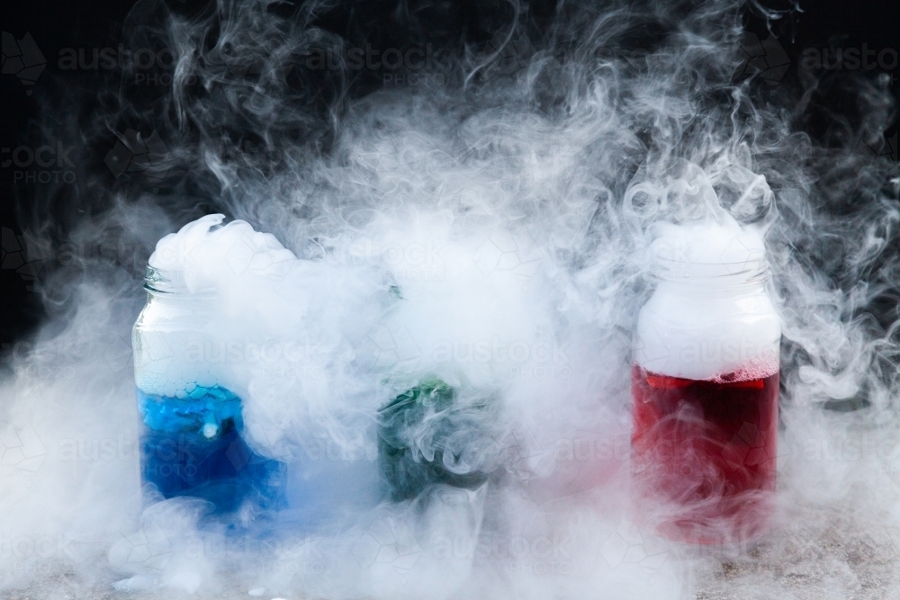Fun science experiment with dry ice and coloured water and detergent - Australian Stock Image