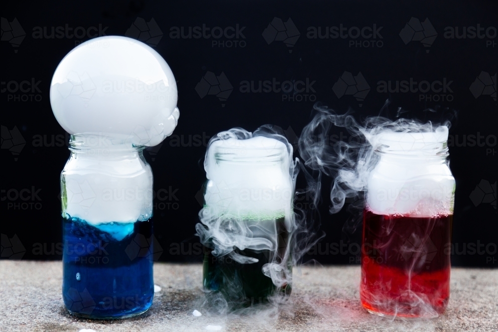 Fun science experiment with dry ice and coloured water and detergent - Australian Stock Image