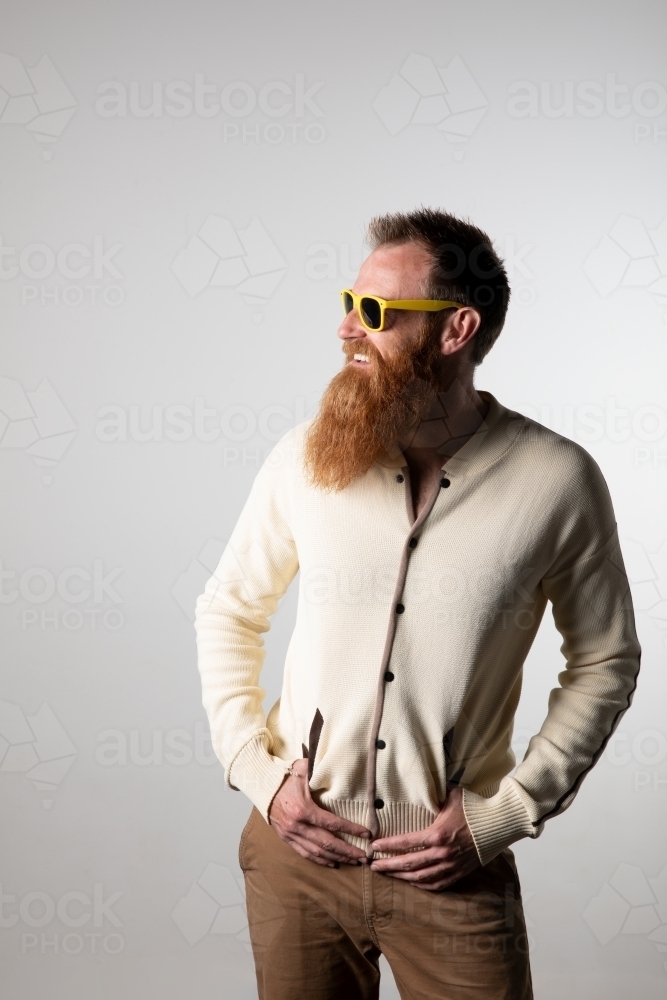 Image of Funky man posing for photographs, wearing a beige shirt ...