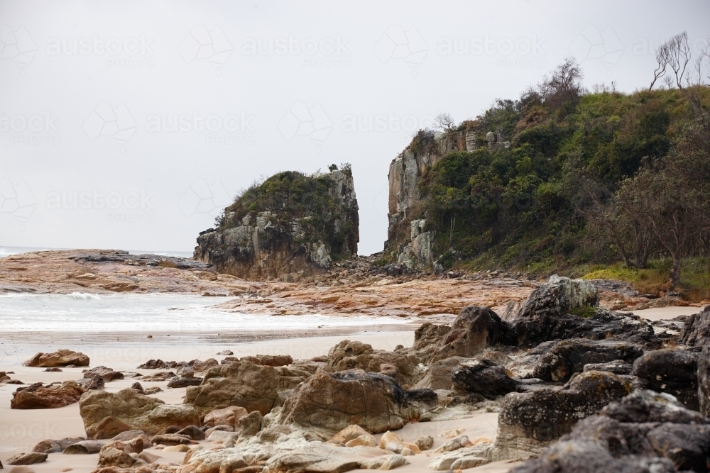 Gap in coastal rocky headland landscape on overcast day - Australian Stock Image