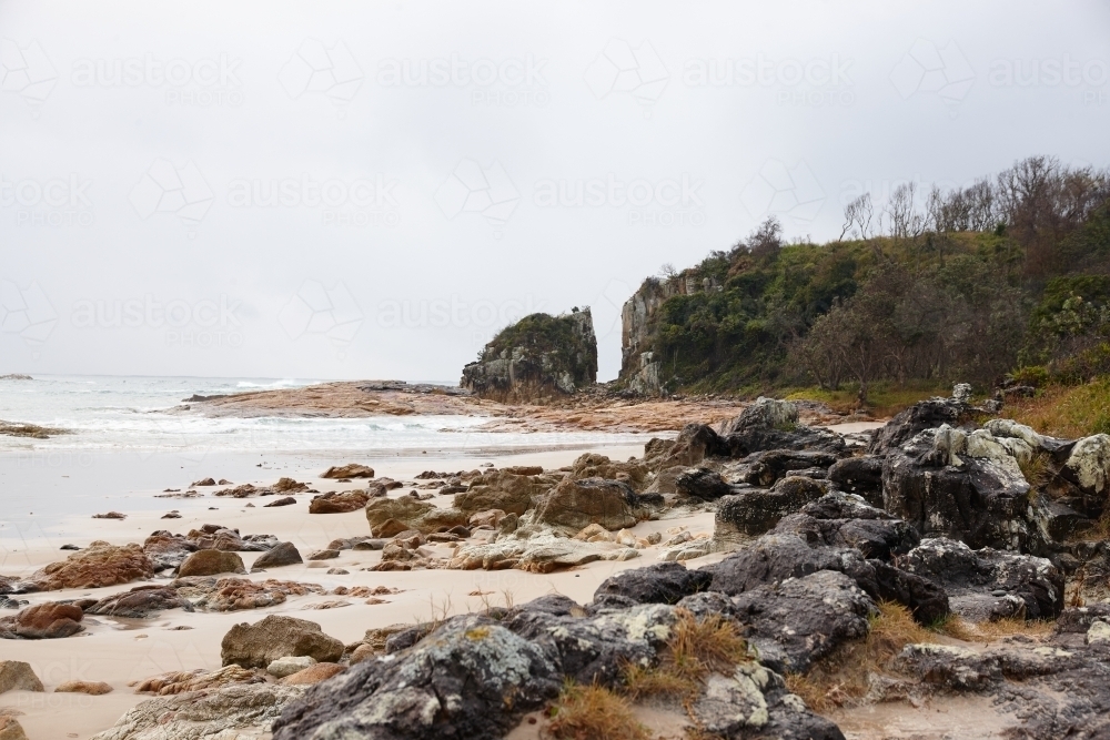 Gap in coastal rocky headland landscape on overcast day - Australian Stock Image