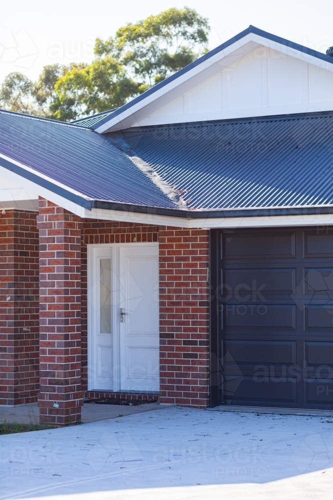 Garage, driveway and front door entrance to new home - Australian Stock Image