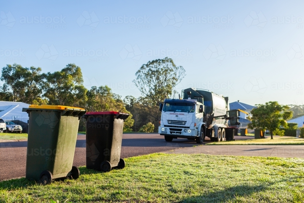 Image of Garbage truck collecting recycling from wheelie bins in