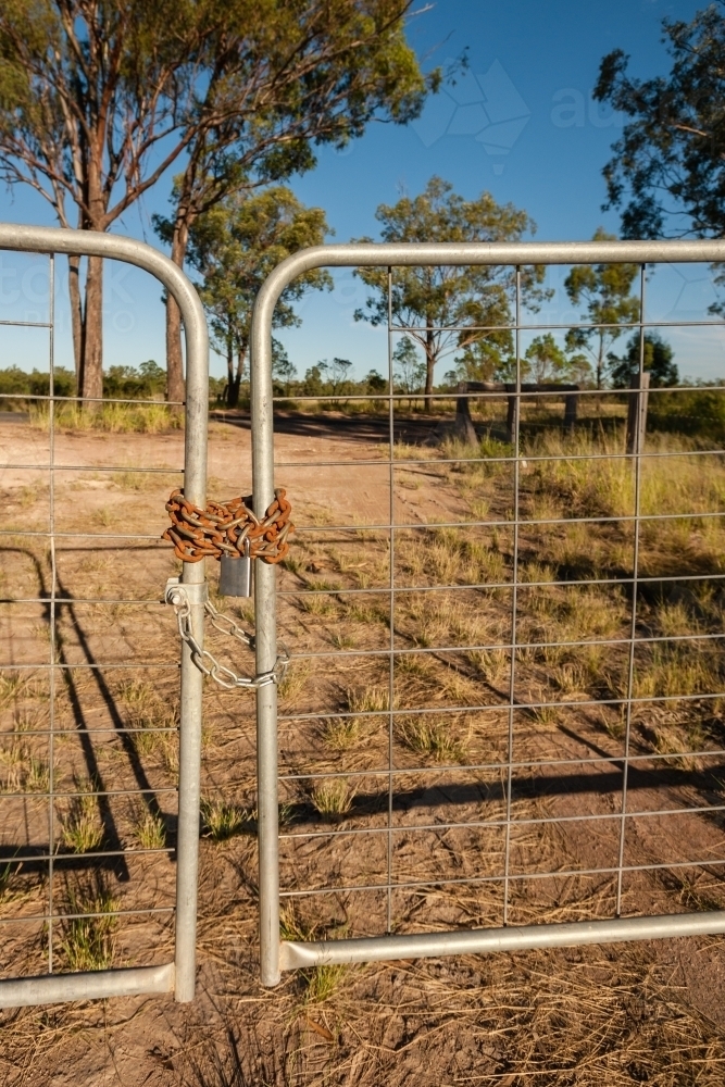 Gate with rusty chain and a padlock - Australian Stock Image