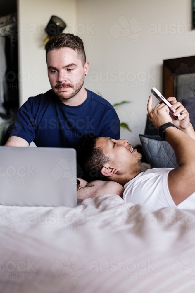 gay couple hanging out at home - Australian Stock Image