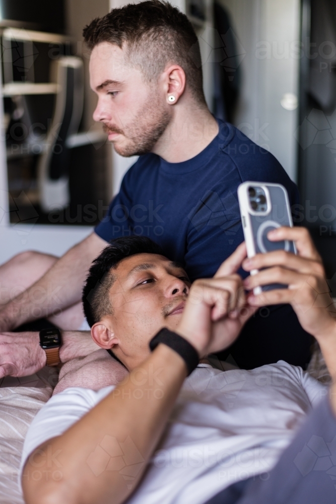 gay couple hanging out at home - Australian Stock Image