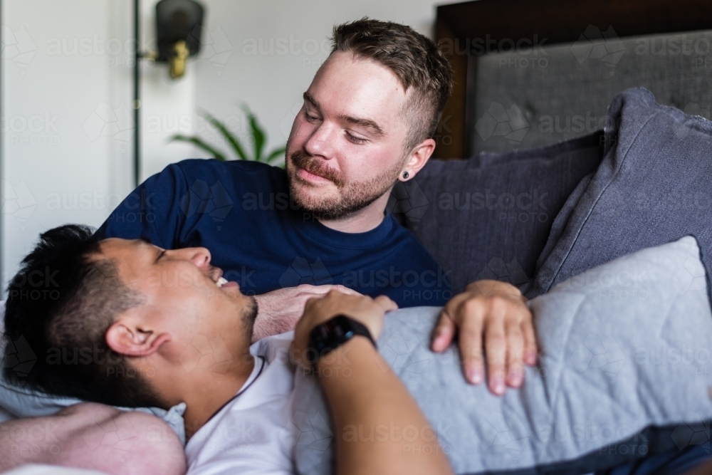 gay couple hanging out at home - Australian Stock Image