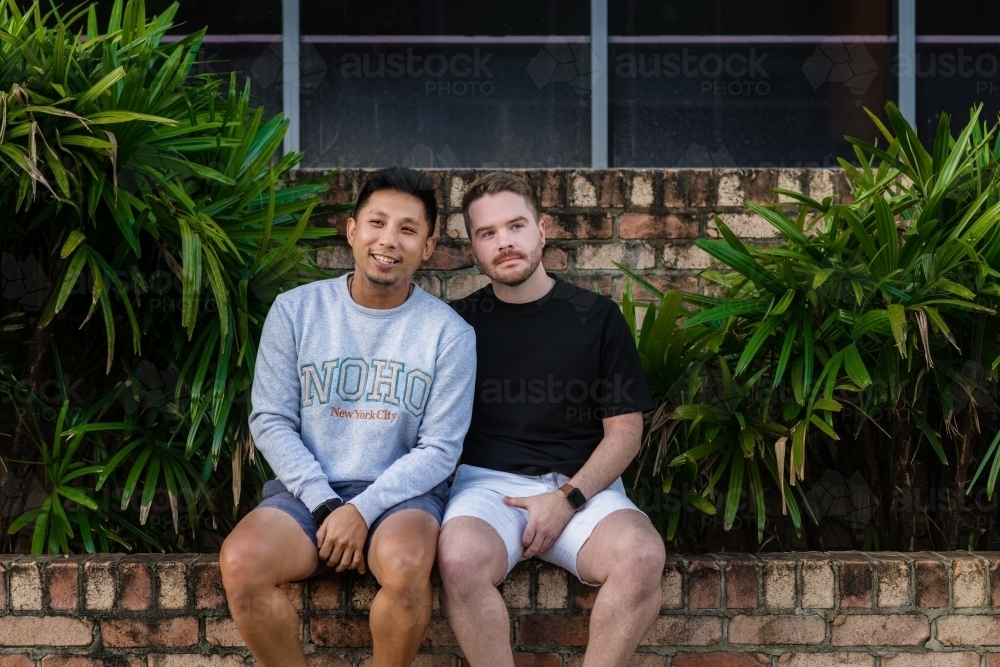 gay men sitting outside their apartment building - Australian Stock Image