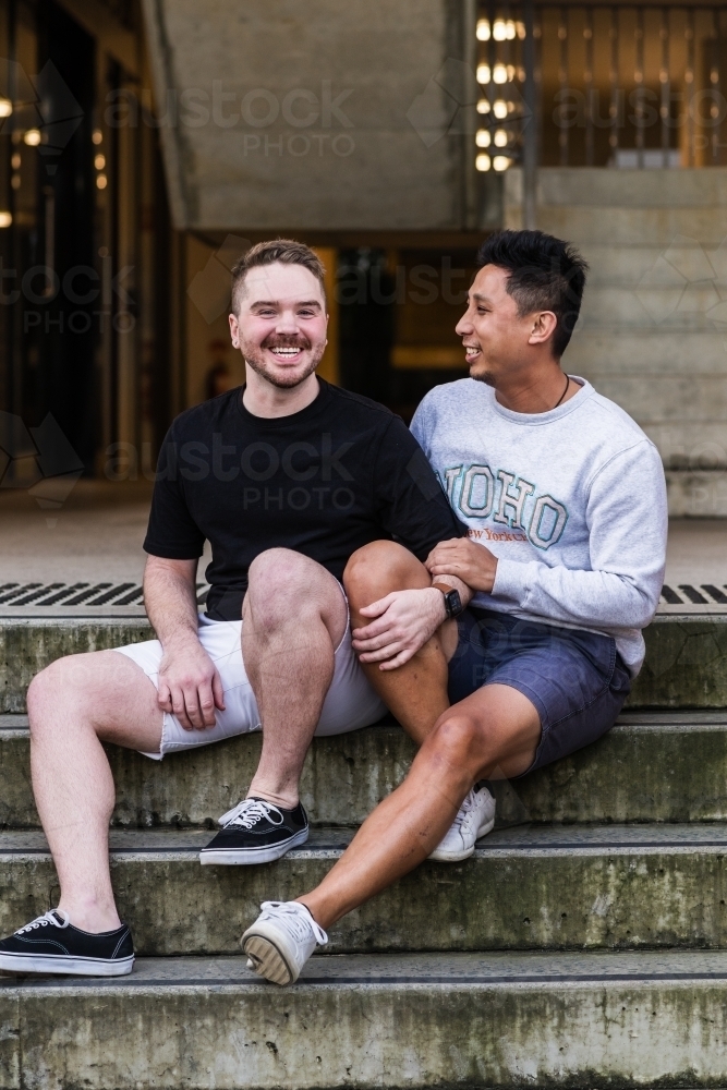 gay men sitting outside their apartment building - Australian Stock Image