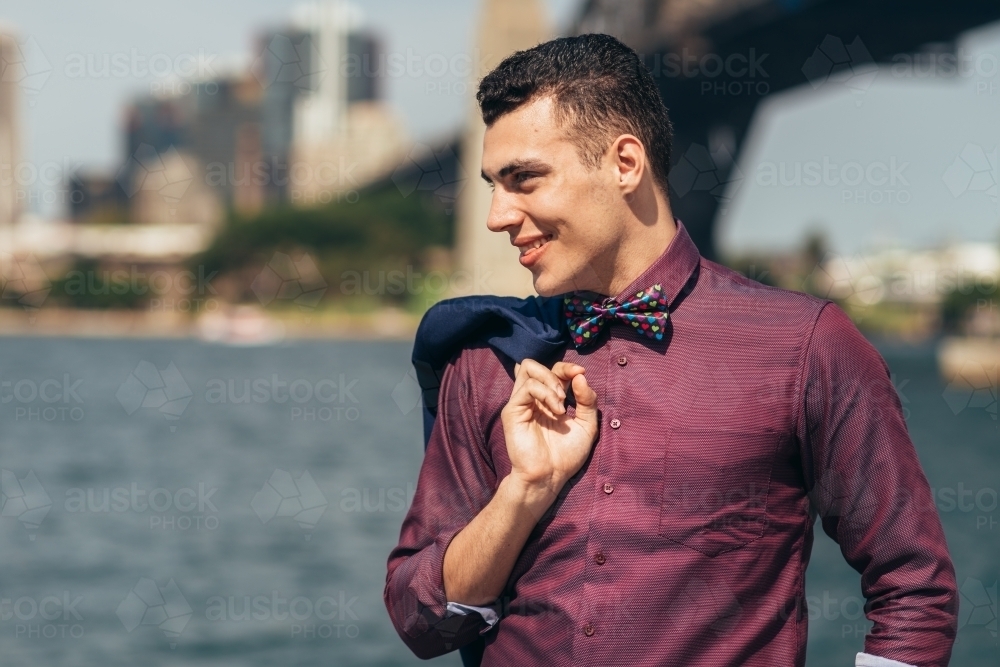 gay young man standing by sydney harbour - Australian Stock Image