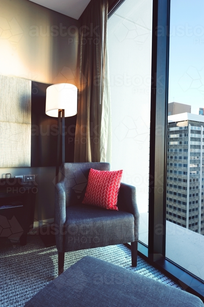 generic apartment or hotel room, chair by window - Australian Stock Image