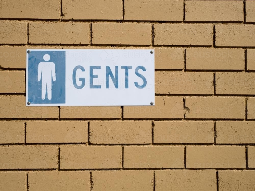 "GENTS" sign on a light coloured brick wall - Australian Stock Image
