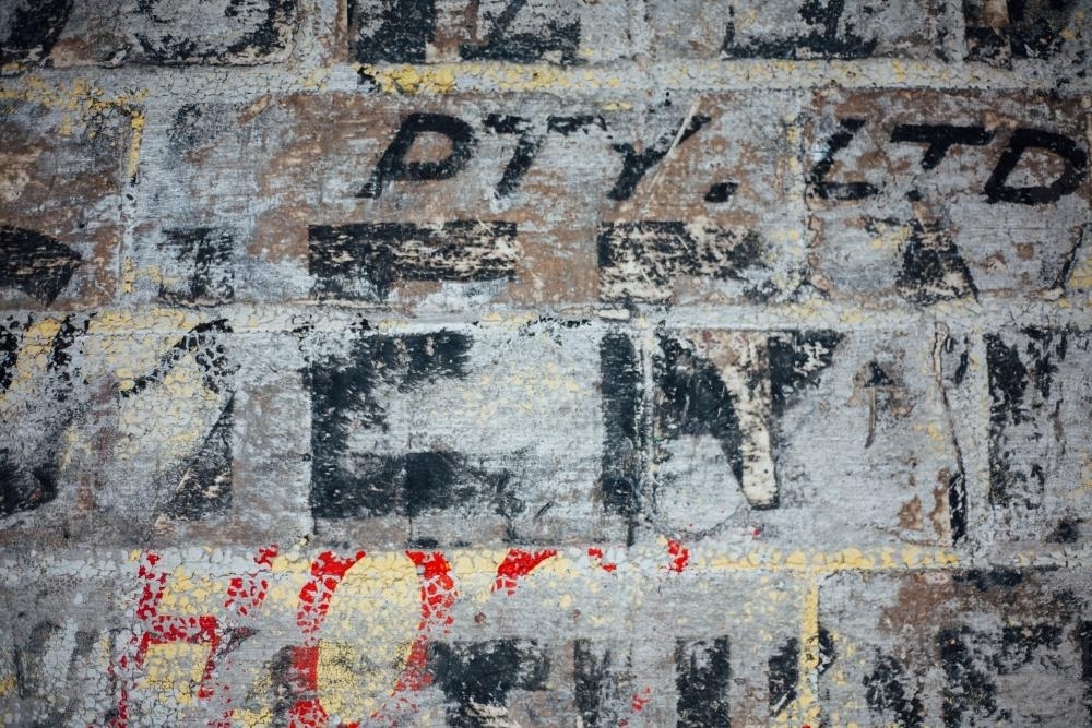Ghost signage on brick wall - Australian Stock Image