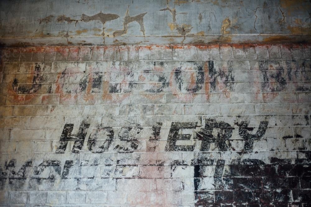 Ghost signage on brick wall - Australian Stock Image