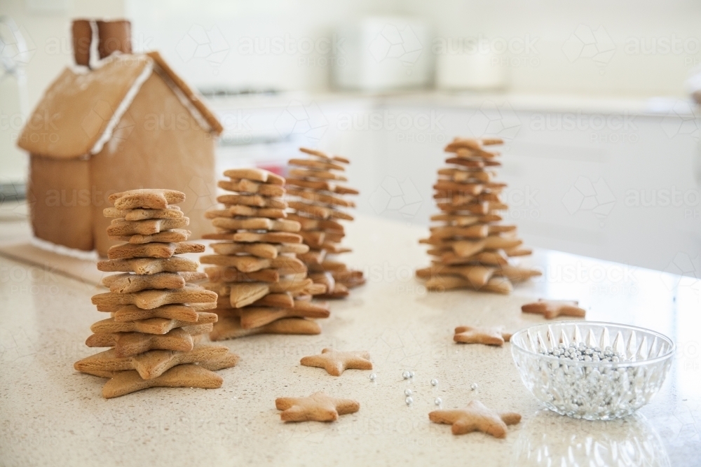 Gingerbread house and Christmas trees made with star biscuits - Australian Stock Image