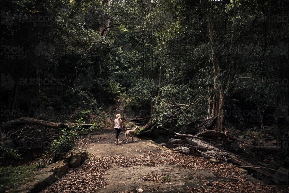 Girl and the dog at the creek - Australian Stock Image